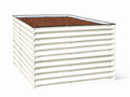 White metal raised garden bed filled with soil