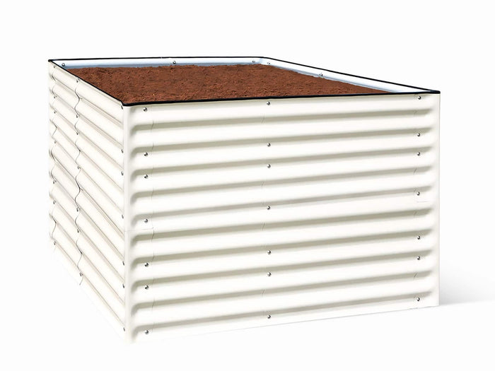 White metal raised garden bed filled with soil